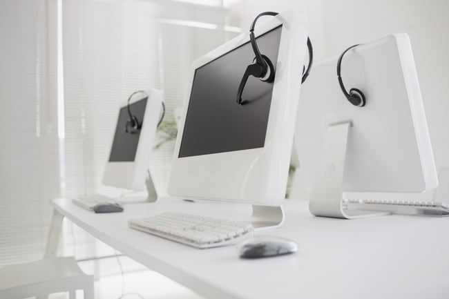 Computers and headsets in empty office-2