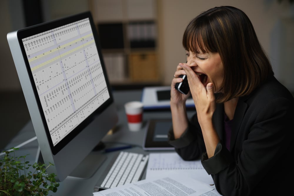 Tired Businessman at her Desk, Showing Yawning Gesture While Talking to Someone on Mobile Phone.-1